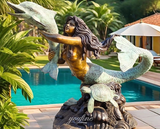 bronze mermaid and dolphin statue