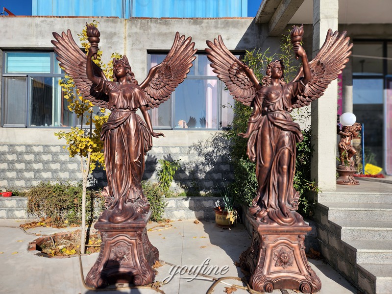 bronze angel with torch