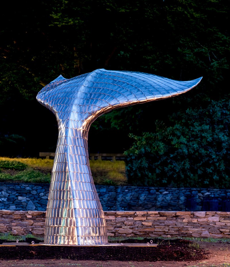 Large Whale Tail Garden Sculpture in Night