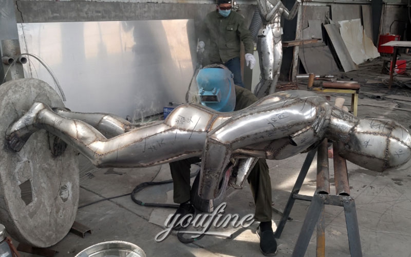 stainless steel couple sculpture in factory