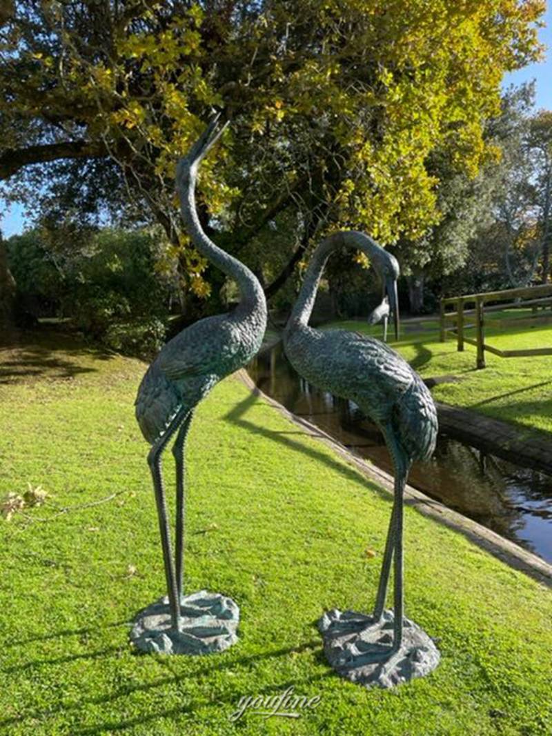 bronze crane sculpture in garden