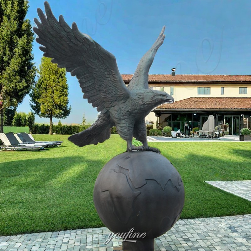 bronze eagle on ball sculpture