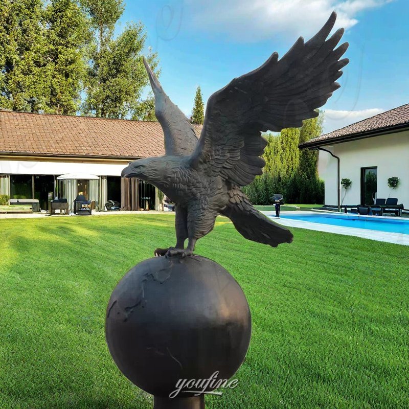 bronze eagle on ball statue