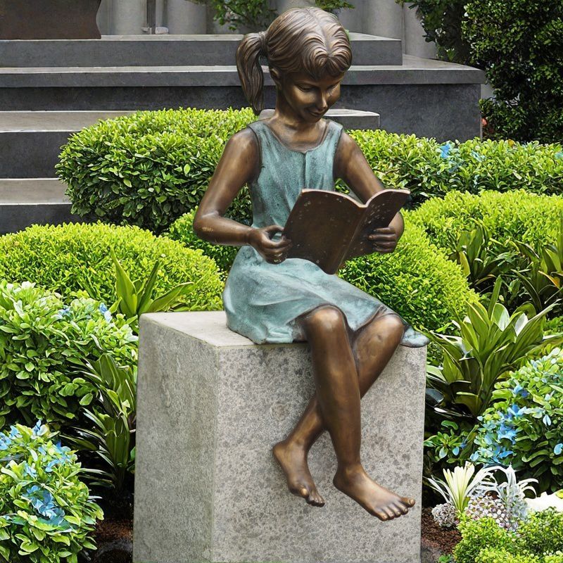 bronze girl reading book statue