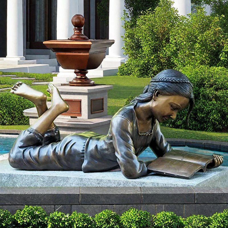 girl reading book sculpture